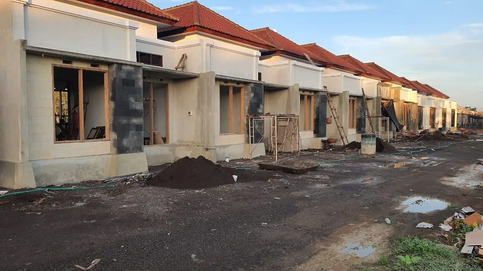 Commercial homes at LC Residence with stone accents and timber window frames during construction