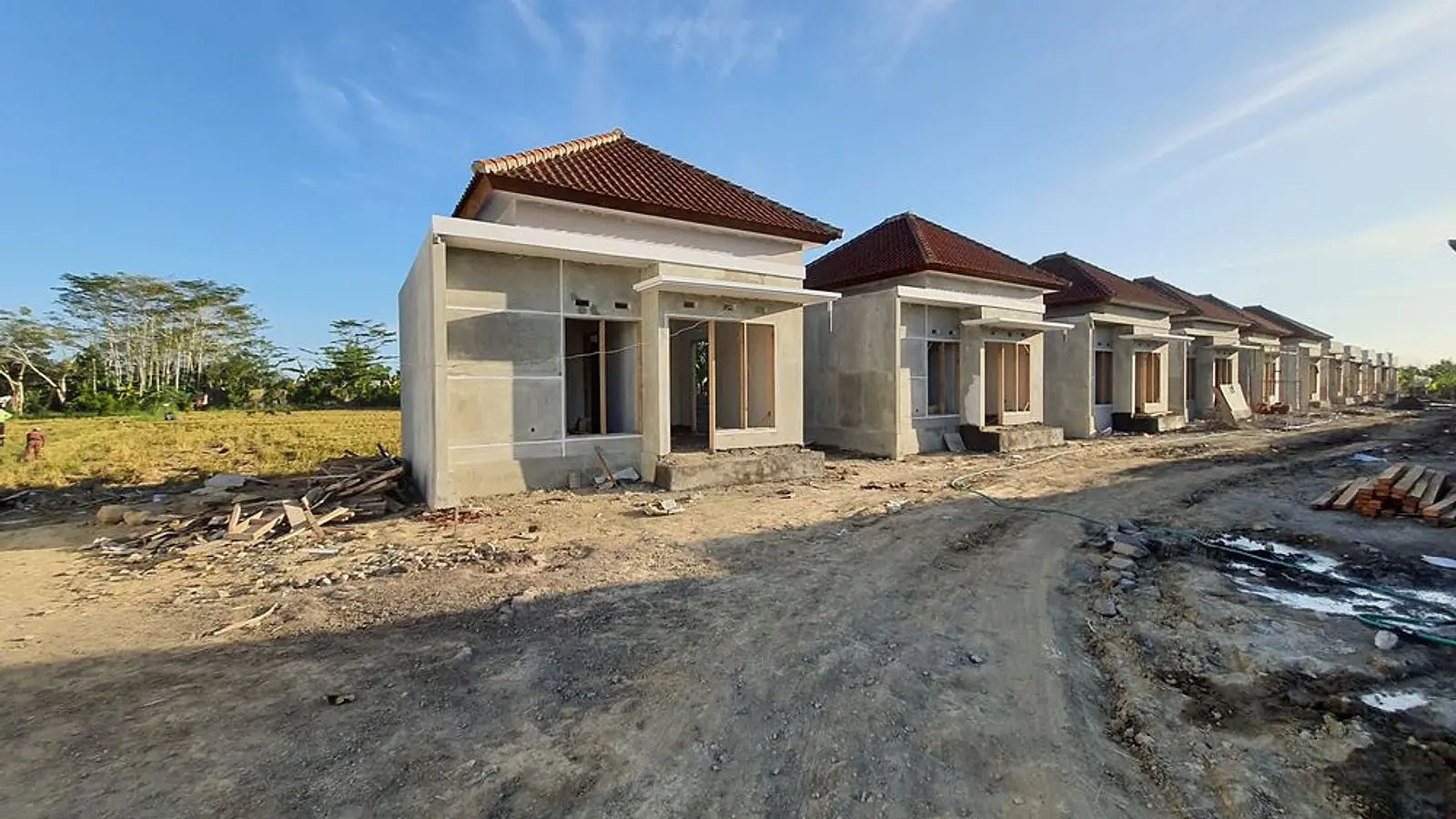 A row of LC Residence homes with tiled roofs during construction
